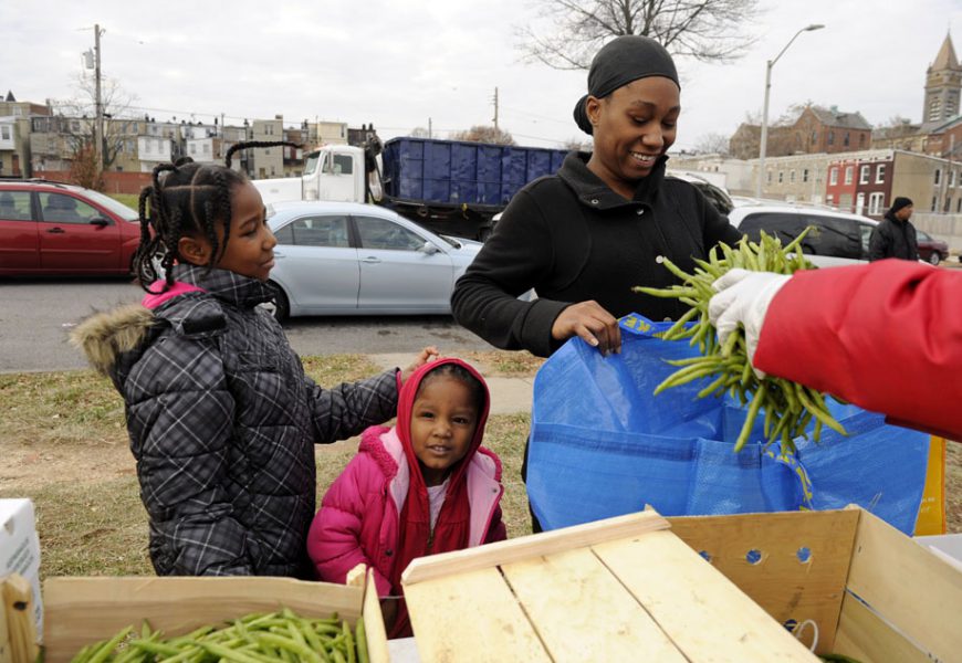 Janelle Desormeaux gets fresh green beans at a farm stand in the Oliver neighborhood