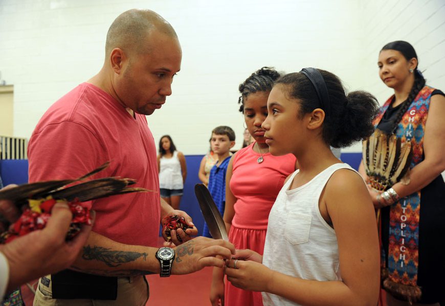 Kiyia Johnson receives her eagle feather from tribe-member Louis Campbell